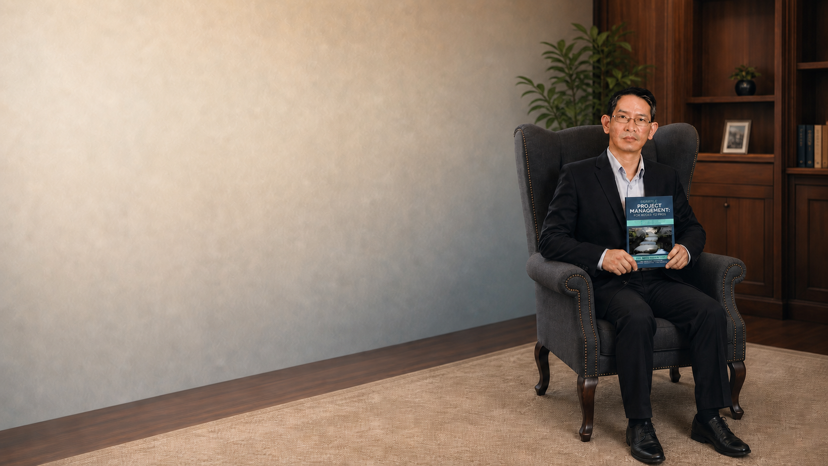 Ng Wei Kwan, PMP seated with a copy of Simple Project Management